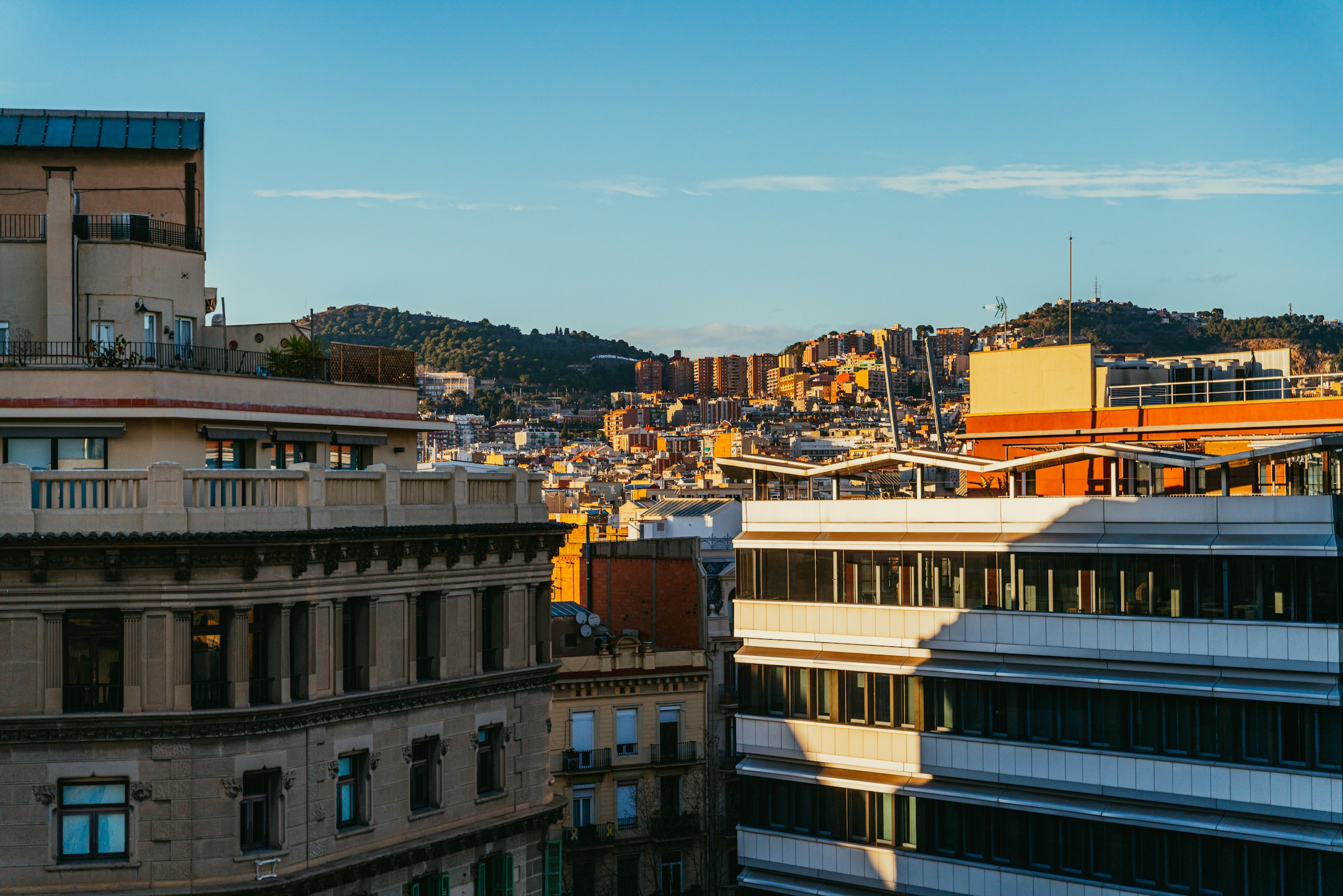 A view of Barcelona's cityscape from a high-rise rooftop