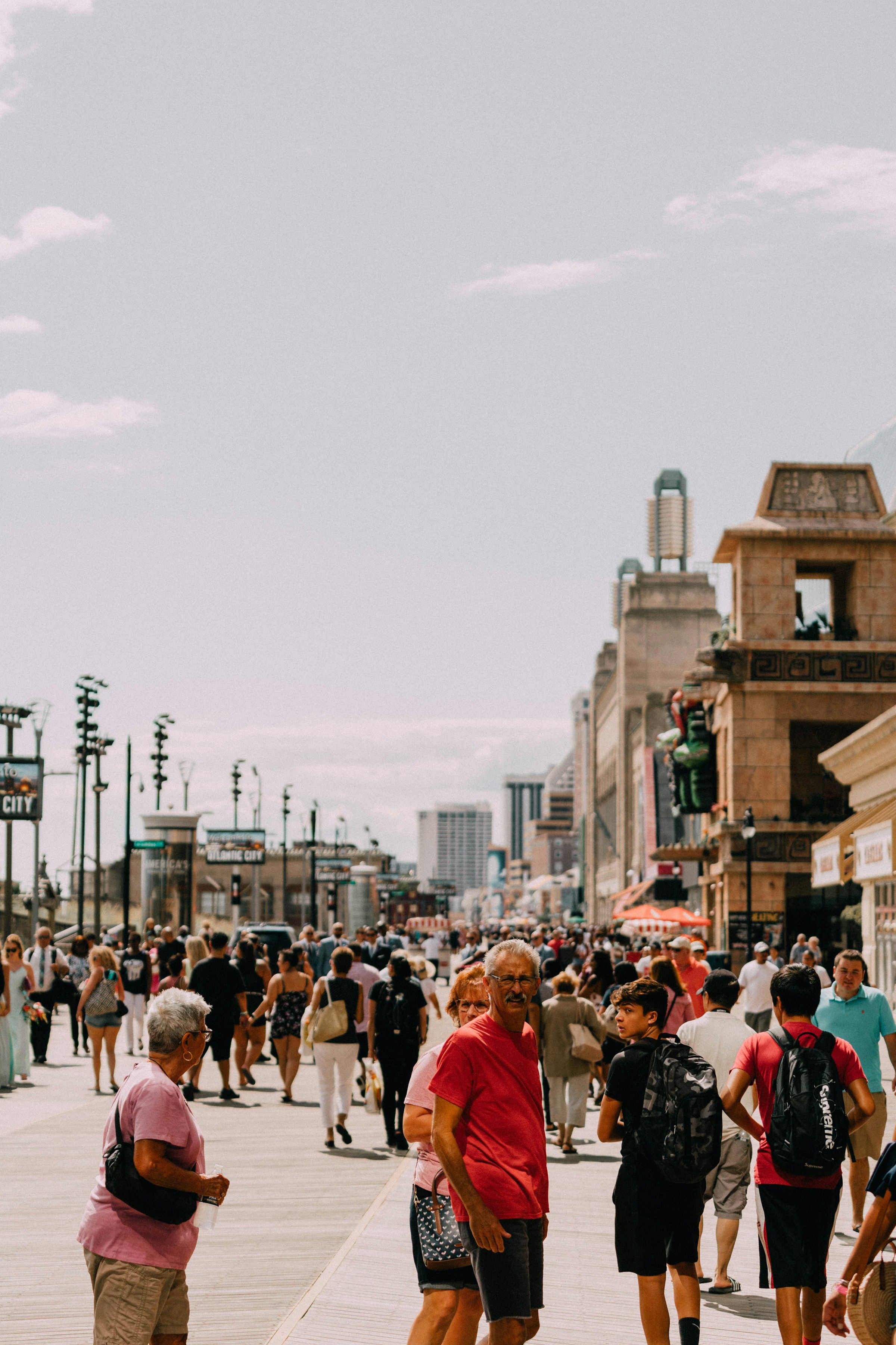 A large group of people walking together on a street during the day